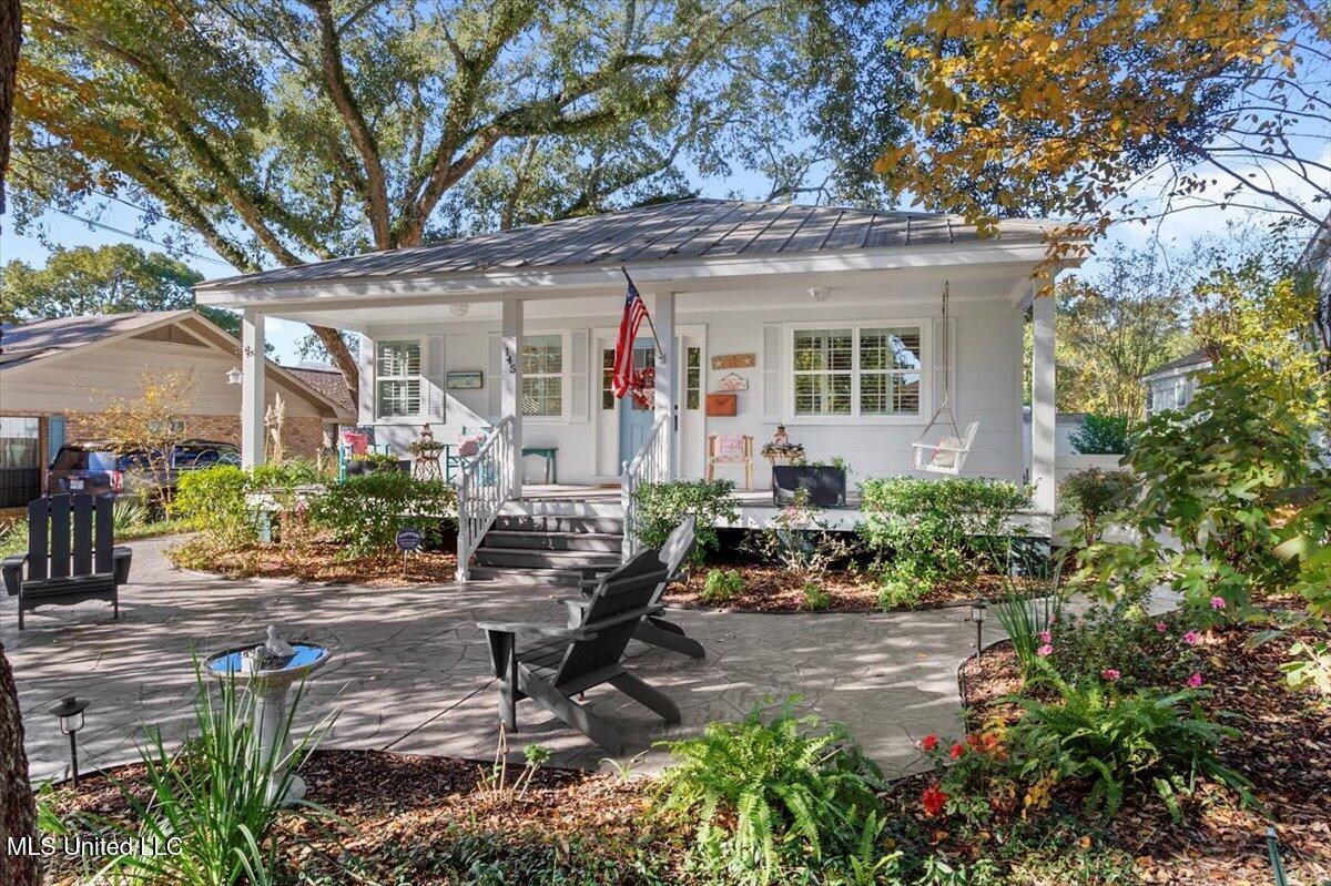 welcome home to this gem! what a gem! one of a kind and won't last long. step into an amazing home full of charm and unique appeal. a great deal of love has been put into this home. the front porch is a great place for a southern beverage with the fresh gulf breeze blowing, while taking in the beautifully landscaped front yard and majestic oak. a very short walk and you are on the beach! the back yard oasis includes an in ground soaking pool and hot tub, outdoor fireplace, stamped concrete that leads all the way to the front of the home, and screened porch. home has custom plantation shutters throughout! many nice touches on the interior that you must see. close to great restaurants and the casinos make this home the perfect location. all of the furnishings remain inside and out with the exception of the patio set in the screen in porch area.
